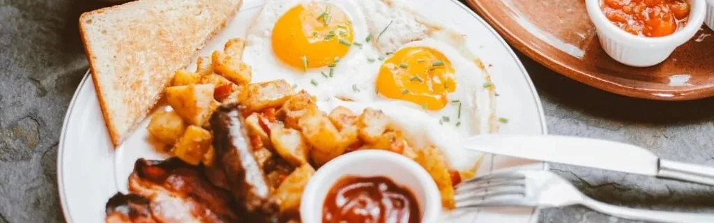 Diner breakfast plate with eggs, bacon, hash browns and coffee