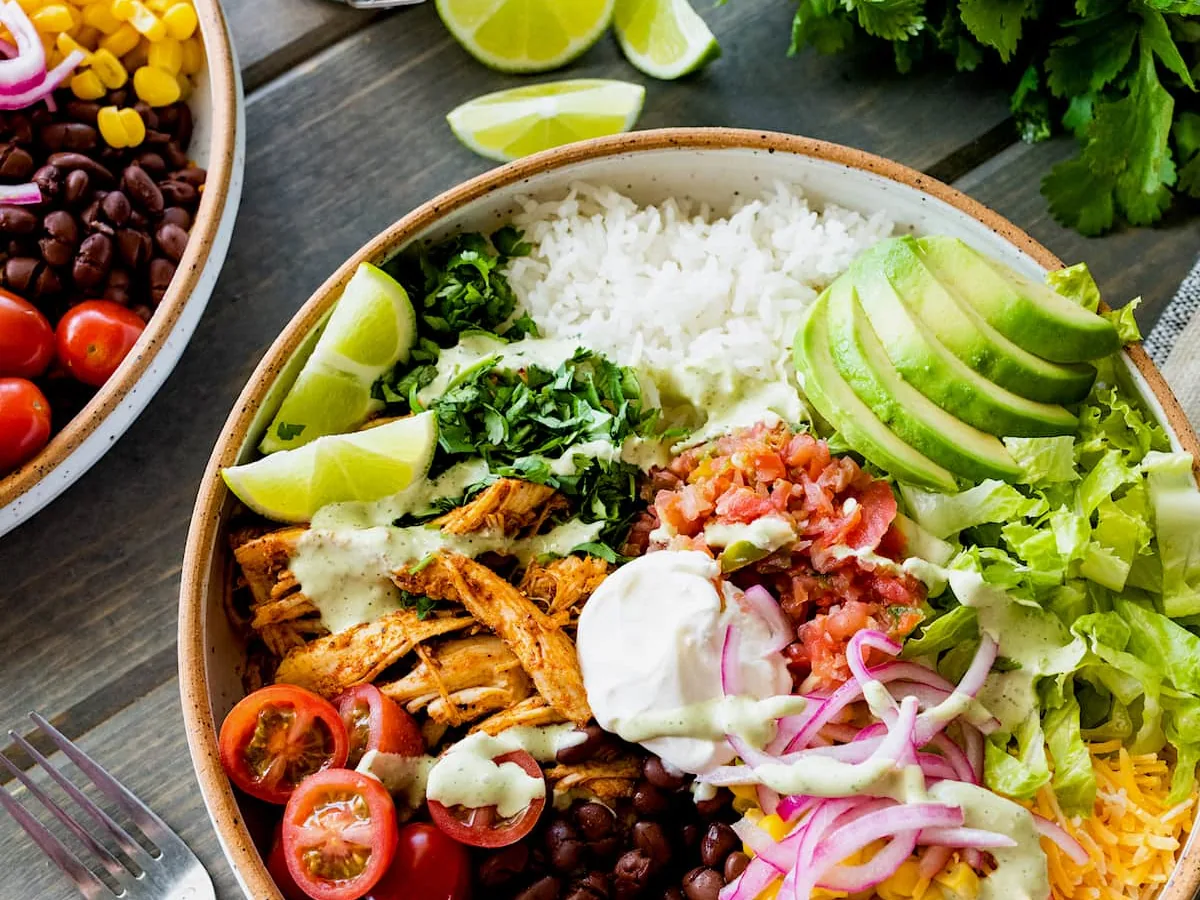 Burrito bowl with chicken, rice, avocado and beans