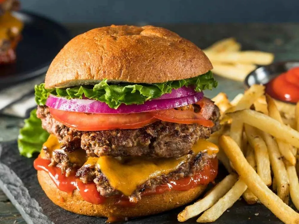 Double beef burger and fries on slate
