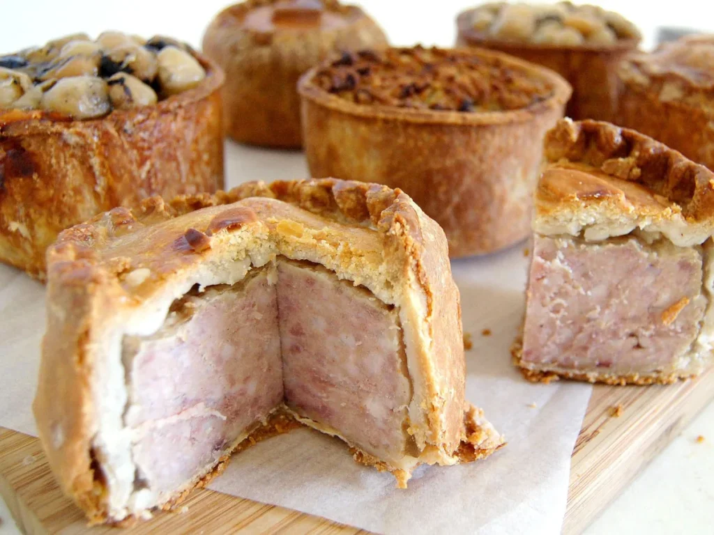 Golden-brown savoury pies and pastries arranged on a tray.