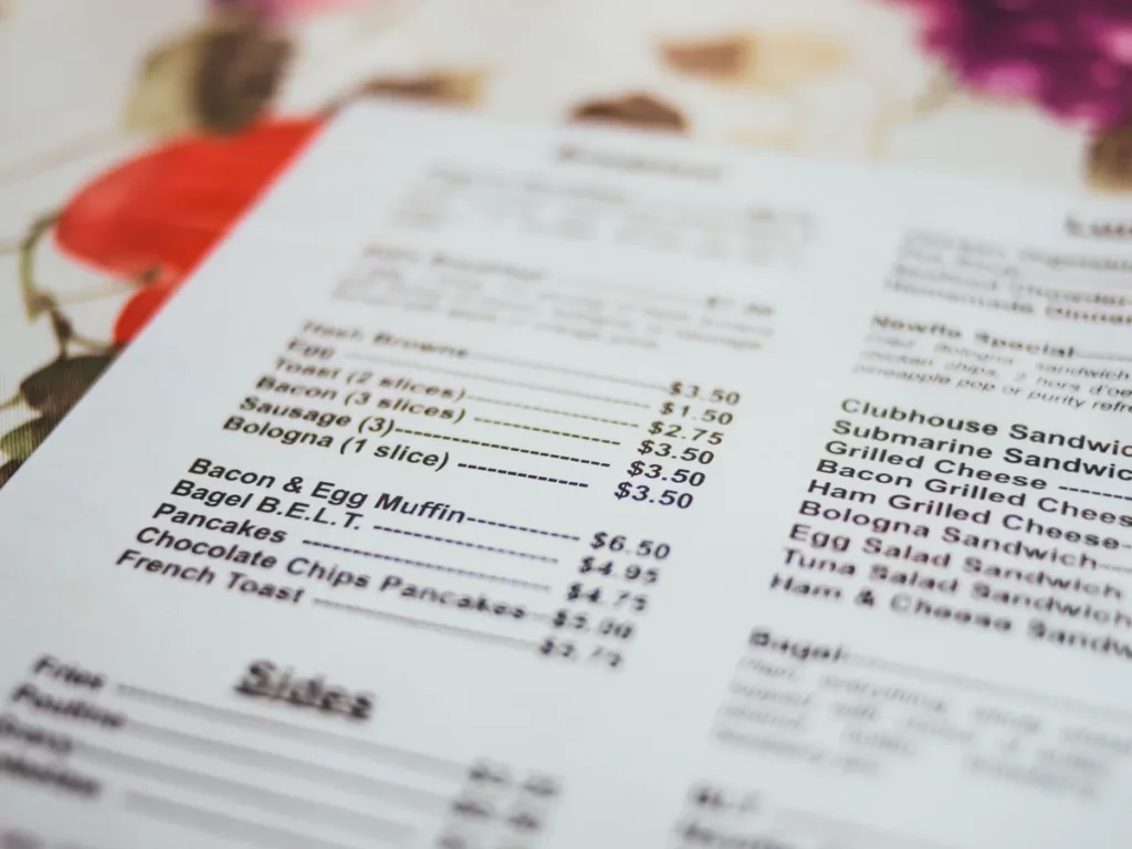 A close-up of a printed menu listing breakfast items and prices.